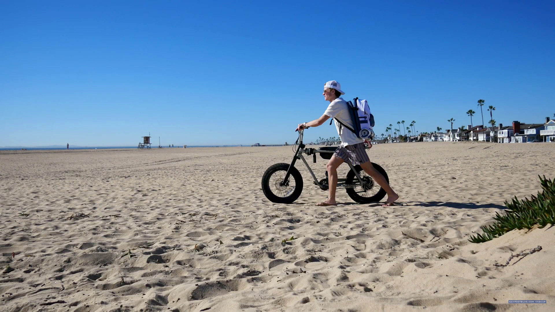 driving his bike to the beach